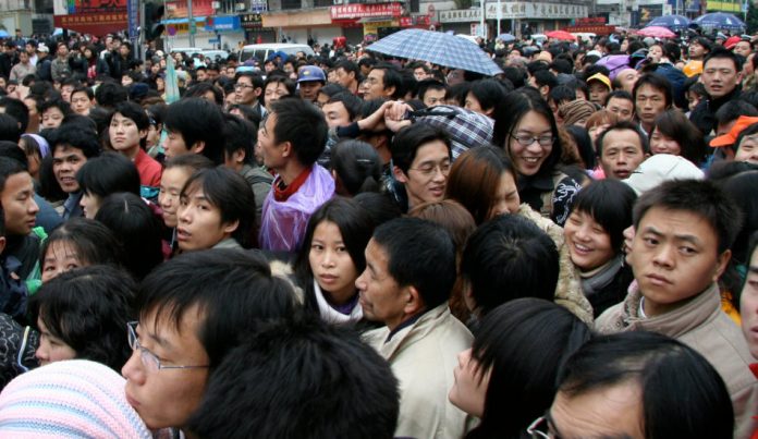 A crowd of people waiting outside the train station in Guangzhou, China.
